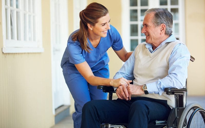 Caregiver helping a senior client at home in Southwest Florida