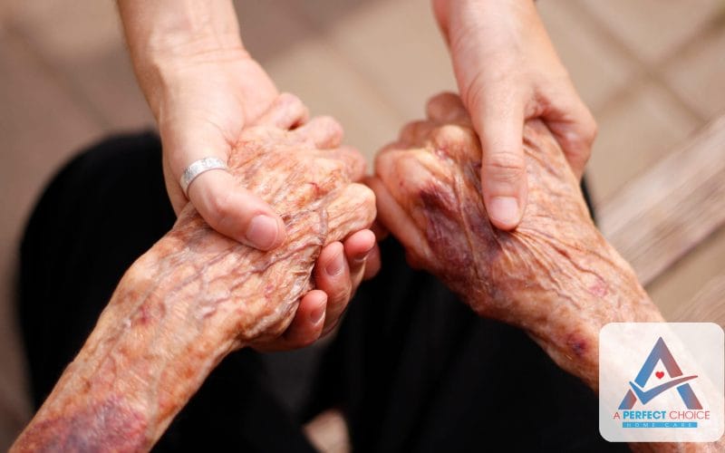 Caregiver holding hands with an elderly client, discussing Medicare and home care coverage in Florida