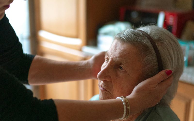 Home caregiver attending to an elderly woman in her Southwest Florida kitchen during in-home care