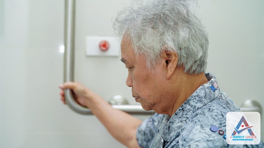 Senior woman using a bathroom grab bar at home for fall prevention