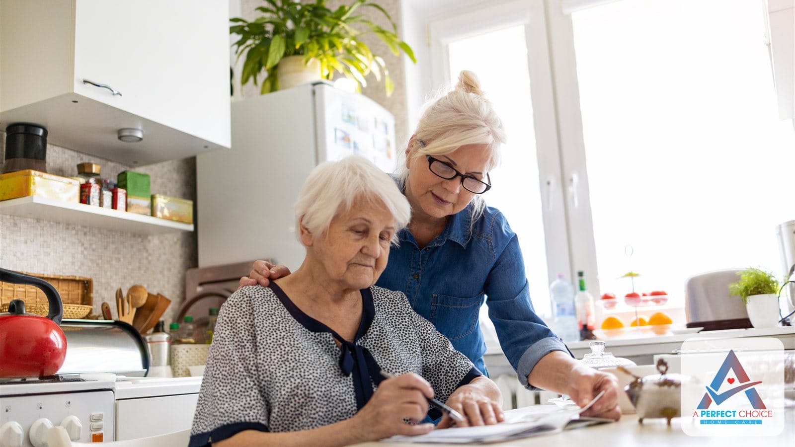 Adult daughter helping her elderly mother review program paperwork at a kitchen table at home